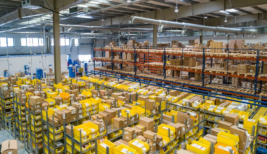 A large distribution warehouse with stacked goods