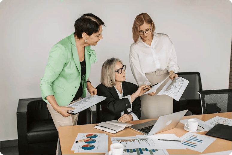 Three colleagues reviewing documents together