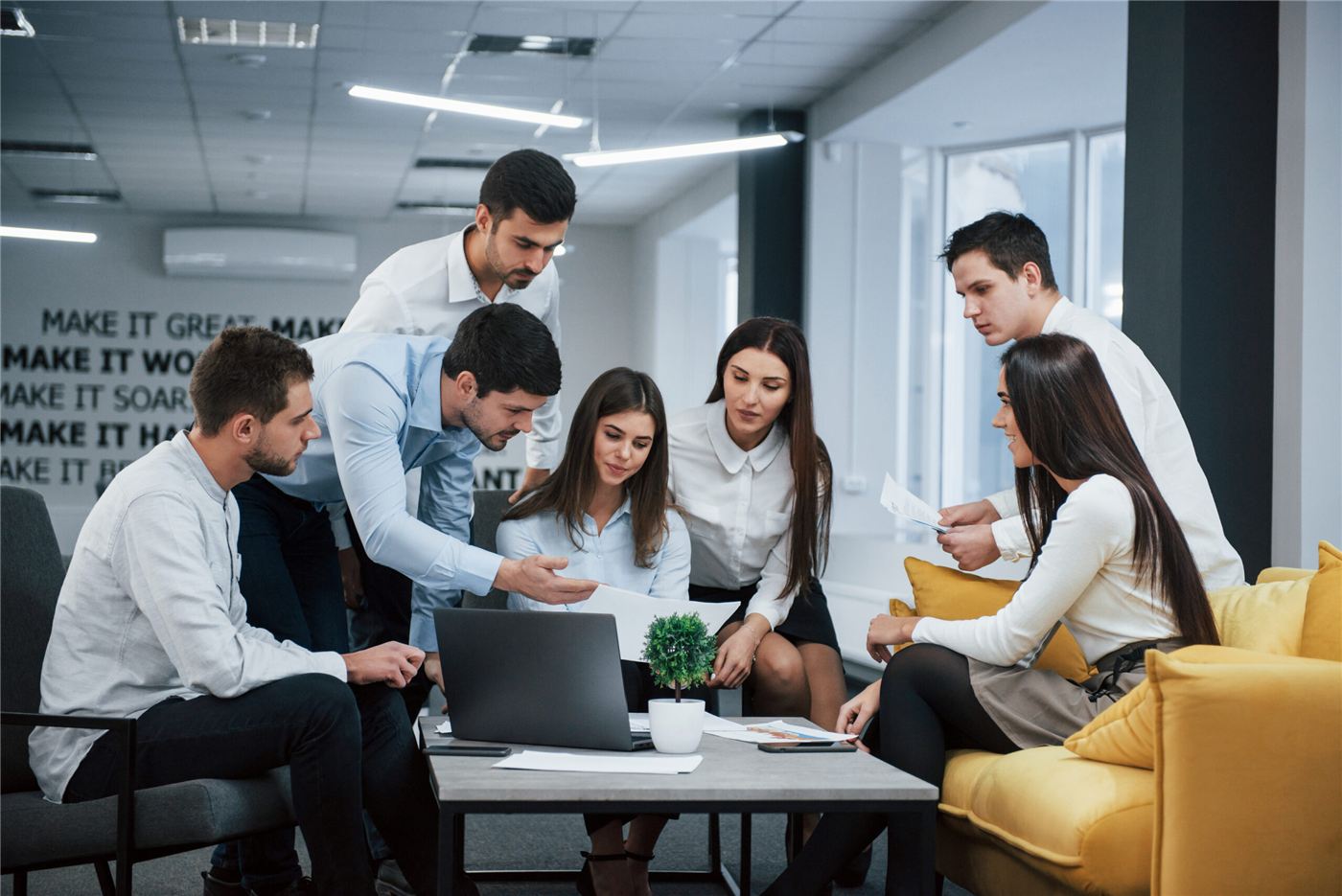 A project team reviewing work together around a table